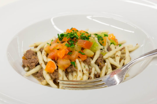 Pasta Strozzapreti with meat sauce and vegetables