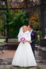bride and groom in autumn park