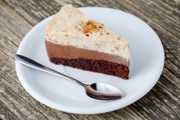 Tasty nuts cake on wooden background.