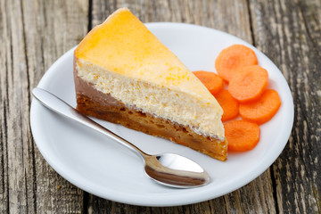 Sweet slice of carrot cake on white plate.