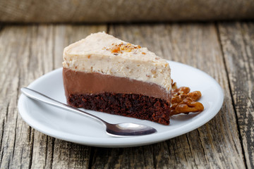 Tasty nuts cake on wooden background.