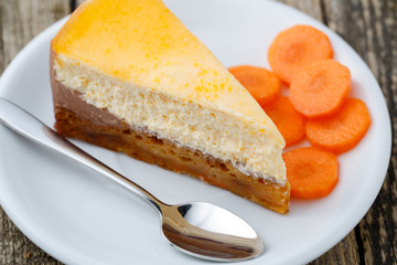 Sweet slice of carrot cake on white plate.