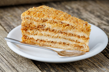 Tasty honey cake on wooden background.