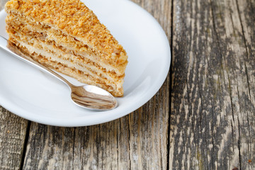 Tasty honey cake on wooden background.