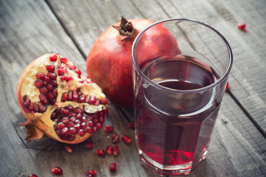 Glass of pomegranate juice with fresh fruits. 