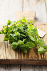 Fresh mint on grey wooden background