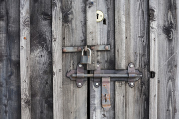 Fragment of wooden door with a key lock.

