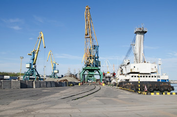 Fototapeta na wymiar Port cranes in sea port