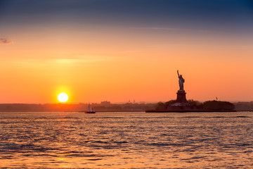 Statue of Liberty at sunset as viewed from Brooklyn, New York