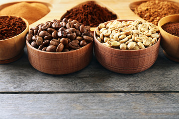 Various of coffee in small dishes on wooden table, closeup