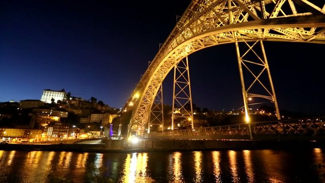  Porto, Portugal with the Dom Luiz I bridge at night time.
