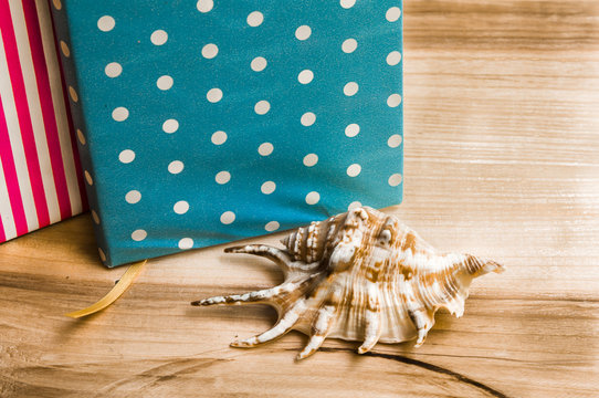 notebook with a seashell on a wooden background