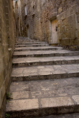 Stone stairs in the old city of Taranto, Puglia, Italy.