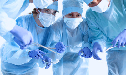 Below view of surgeons holding medical instruments in hands 