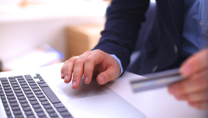 Businessman using his credit card for an online transaction