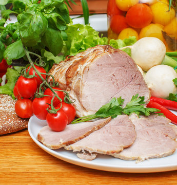 Ham with vegetables on white plate