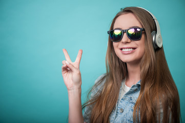 Cheerful Hipster woman with headphones and glasses