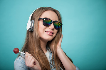 Cheerful Hipster woman with headphones and candy