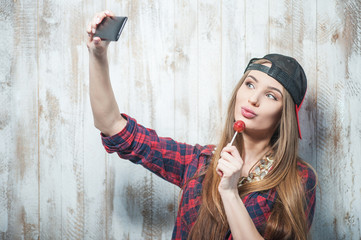 Cheerful Hipster woman with hat and candy