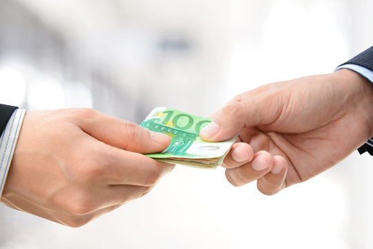 Businessman hands passing money, Euro currency (EUR)