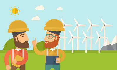 Two workers talking infront of windmills.