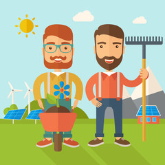 Two men with wheelbarrow and rake.