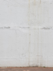 old peeling white wall and tiled floor