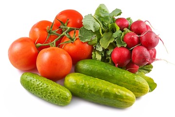 Tomatoes, cucumbers and radishes on a white background