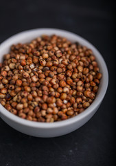 Sorghum in a white bowl on a black background
