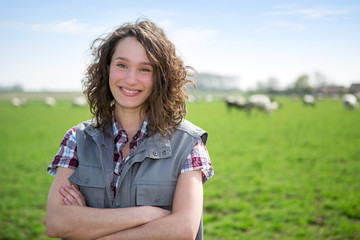Portrait of a young attractive farmer in fields