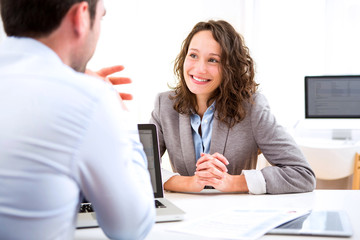 Young attractive woman during job interview - obrazy, fototapety, plakaty