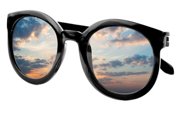 Sunglasses have a sunrise sky reflecting on  isolated  backgroun