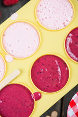 filling ice cream moulds with homemade juice