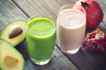 two fresh blended fruit smoothies made with avocado, pomegranate