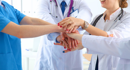 Doctors and nurses in a medical team stacking hands 