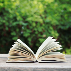 Open book on wooden table
