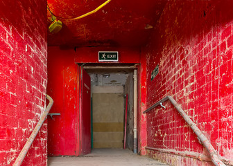 Destroyed staircase with emergency exit in an old building.