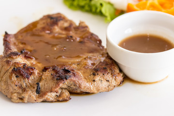 Close up of pork steak on a white plate