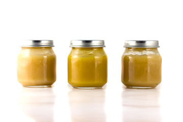 Three jars of fruit puree in a row 