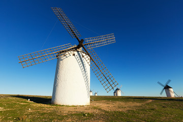 Fototapeta na wymiar Wide angle shot of group of windmills in sunny day