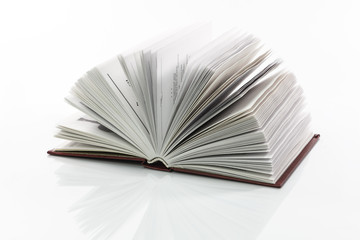open book reflected on white background