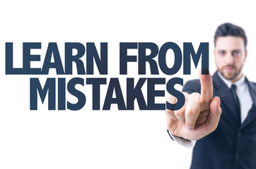 Business man pointing the text: Learn From Mistakes