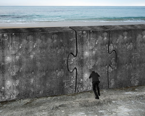 Man pushing huge puzzle door of concrete wall