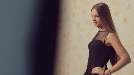 Slim model with long hair posing for a photographer at photo