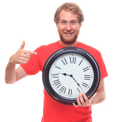 Bearded happy man holding big clock and smiling