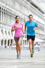 Running runner couple jogging in Venice