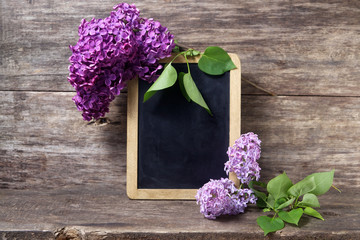 Lilac flowers in a vase and blackboard 