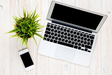 Office desk table with laptop computer and flower