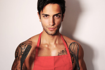 sexy man holding a whip for cooking