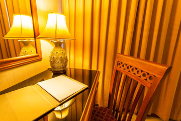 notebook on the table with lamp and chair in retro style